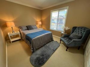 a bedroom with a bed and a chair and a window at Terra Nova - Private property in Richmond