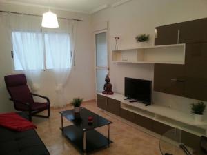 Televízia a/alebo spoločenská miestnosť v ubytovaní Apartment Huerto