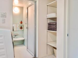 a small bathroom with a shower and a toilet at Charlie's House in Osaka