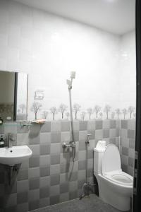 a bathroom with a toilet and a sink at Naomi House Phan Thiet in Phan Thiet