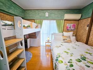 a bedroom with a bed and a bunk bed at 703 Family room Near Kiowa station walk 1min in Tokyo