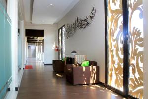 a living room with a couch and a hallway at Choice Stay Hotel Denpasar in Denpasar