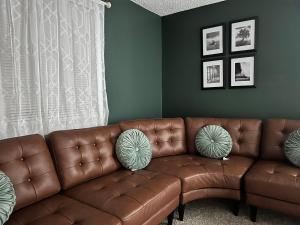 a living room with a brown leather couch at Down town Anchorage 3 in Alaska Regional Hospital Heliport