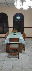 a dining room table with chairs and a blue table cloth at El Paraíso Escondido in San Luis