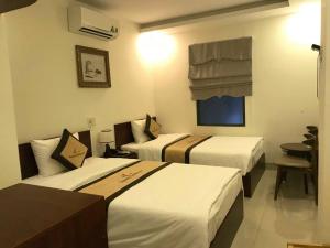 Rúm í herbergi á Danang Classic Hotel