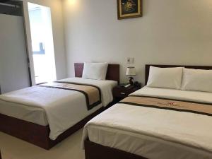 Rúm í herbergi á Danang Classic Hotel