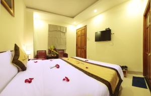 Rúm í herbergi á Danang Classic Hotel