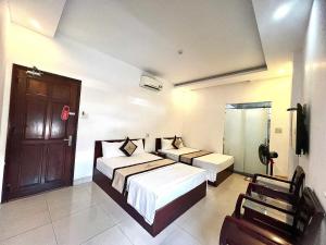 Rúm í herbergi á Danang Classic Hotel