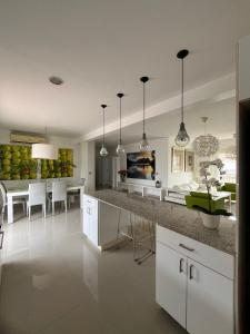 a kitchen with a counter and a dining room at bello PH cerca de la playa in Punta Cana