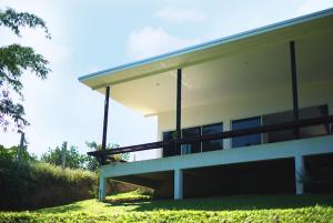 a large building with a grassy yard in front of it at Takraw Rim Kwae ตะคร้อริมแคว in Ban Pong Pat +2 photos