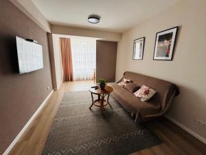 a living room with a couch and a table at Milescu Residence in Chişinău