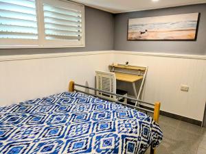 a bedroom with a bed and a desk and a table at Superior Private Bedroom & Ensuite - City & Strand Beach Location in Townsville