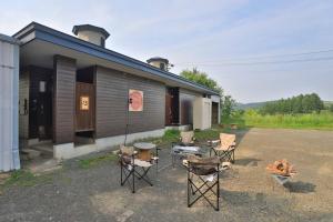 a group of chairs sitting outside of a building at Starry Sky Cottage 13 in Kitami