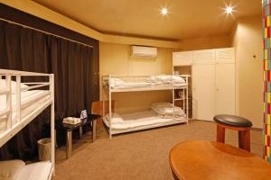 a room with two bunk beds and a table at Starry Sky Cottage 13 in Kitami