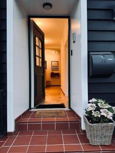 a hallway of a house with a door and flowers at Ferienhaus chez nous in Merzig