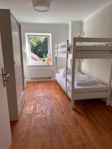 a room with two bunk beds and a window at Ferienhaus chez nous in Merzig