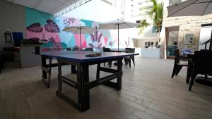 a table with chairs and umbrellas in a room at Hotel Casa Bellamare in Cartagena de Indias
