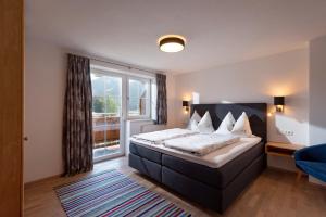 a bedroom with a bed and a large window at Appartement Christine in Brixen im Thale