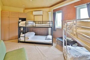 a room with three bunk beds in it at Starry Sky Cottage 15 in Kitami