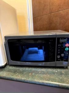 a microwave sitting on top of a counter at Starry Sky Cottage 15 in Kitami