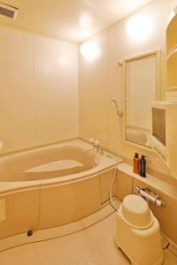 a bathroom with a tub and a toilet in it at Starry Sky Cottage 15 in Kitami +48 photos