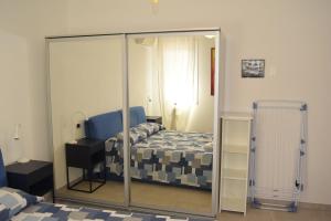 a bedroom with a bed and a mirror at B&B We CaRe Appartamento in Lendinara