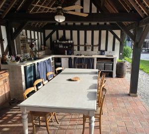 a white table and chairs in a kitchen at La Soulterie in Crouttes +2 photos