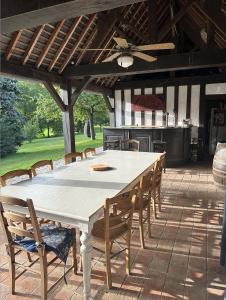 a large white table and chairs on a patio at La Soulterie in Crouttes