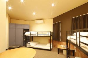 a room with three bunk beds and a table at Starry Sky Cottage 16 in Bihoro +48 photos