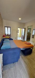 a large blue bed in a room with windows at La Corte di Nonno Gino in Stresa