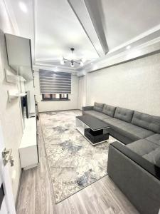 a living room with a couch and a table at Harmony Homestay in Samarkand