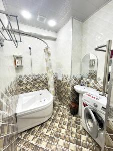 a bathroom with a sink and a washing machine at Harmony Homestay in Samarkand