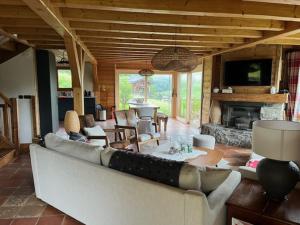 a living room with a couch and a fireplace at Chalet Camomille in Les Gets