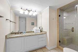 a bathroom with a sink and a shower at romar place 304 in Romar Beach