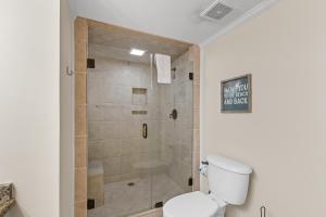 a bathroom with a shower with a toilet at romar place 304 in Romar Beach
