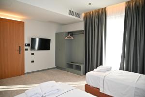 Postel nebo postele na pokoji v ubytování Adria Palace