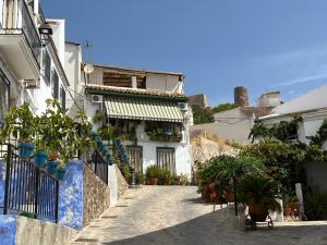 a street with houses and plants on a hill at La Casa de la Luz en la Subbética in Carcabuey