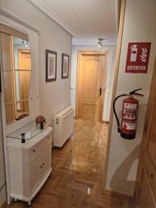 a room with a hallway with a sink and a mirror at Apartamento Cueto in Soto del Barco
