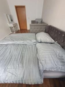 an unmade bed in a bedroom with a bed frame at Eigentumswohnung in Dresden in Dresden +6 photos