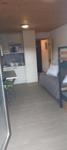 a small room with a bed and a kitchen at studio au pied des pistes in Bolquere Pyrenees 2000