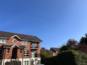 a red brick house with a black roof at Belfast Skyline Retreat - 3 Bedroom Apartment with Free Parking in Belfast