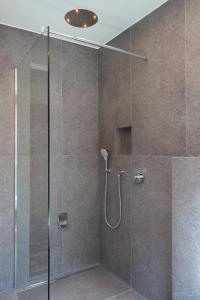 a bathroom with a shower with a glass door at Rumwaldhof - Wohnung Enzian in Solda