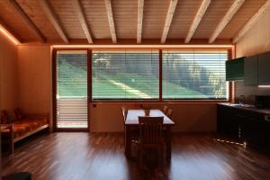 a living room with a table and some windows at Rumwaldhof - Wohnung Enzian in Solda +17 photos