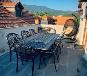 a table and chairs on a patio with a view at Apartment Antiokia in Mtskheta