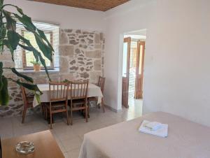 a room with a table and a dining room at Apartments Ante in Lumbarda