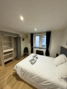 a bedroom with a white bed and a window at Nancy Blue Stan in Nancy