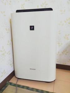 a white refrigerator sitting on top of a wall at SECRET BASE Station Side in Osaka