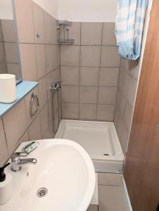 a small bathroom with a sink and a tub at Apartments Ante in Lumbarda