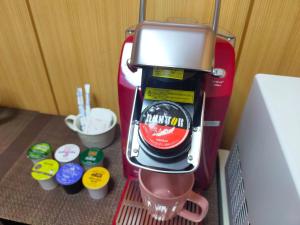 a kitchenaid mixer sitting on a shelf next to a refrigerator at SECRET BASE Station Side in Osaka