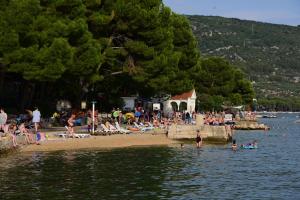 a group of people on a beach near the water at Room Tinna Cres in Cres